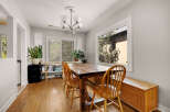 This charming dining area features a rustic wooden dining table with four matching chairs, perfect for family meals.