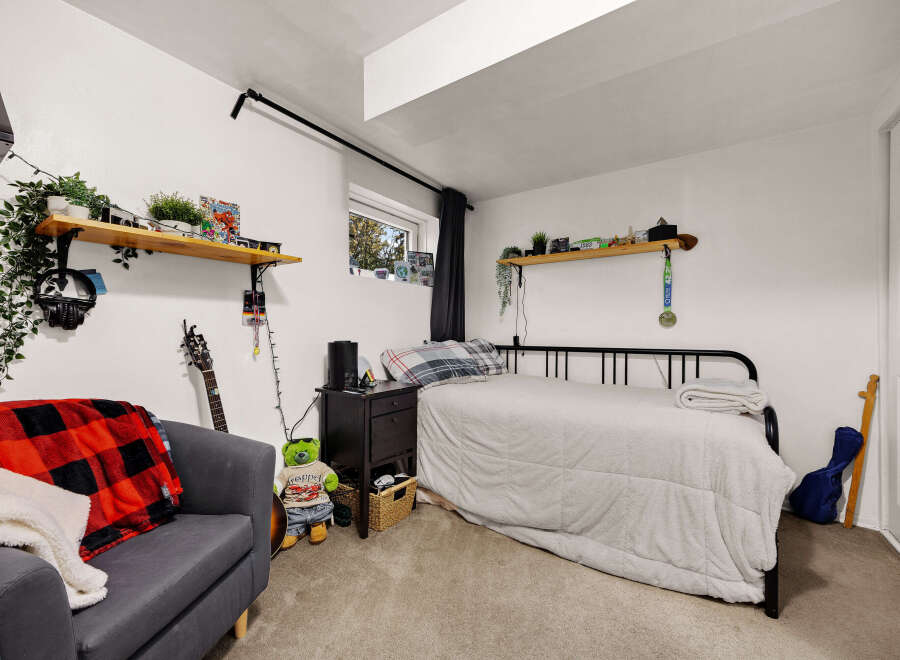 Discover a cozy bedroom featuring a comfortable bed with plush bedding and a stylish black metal frame.