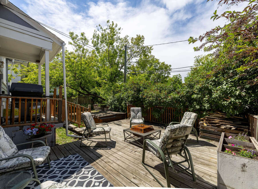 Enjoy outdoor living on this spacious wooden deck, perfect for entertaining or relaxing.