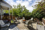 Enjoy outdoor living on this spacious wooden deck, perfect for entertaining or relaxing.