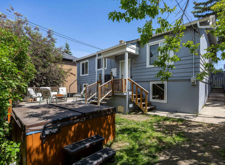 Enjoy outdoor living with this property's spacious deck and relaxing hot tub, perfect for unwinding.