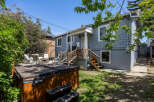 Enjoy outdoor living with this property's spacious deck and relaxing hot tub, perfect for unwinding.
