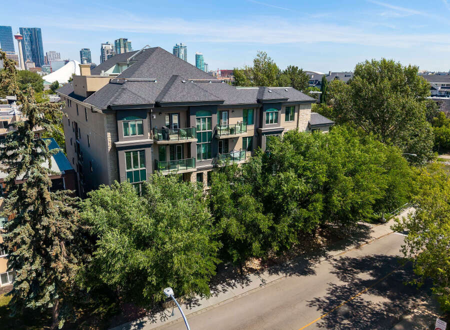 Experience modern living in this stunning multi-story apartment building, featuring private balconies with glass railings perfect for enjoying the outdoors.