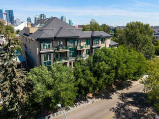 Experience modern living in this stunning multi-story apartment building, featuring private balconies with glass railings perfect for enjoying the outdoors.