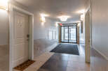 Welcome to this inviting apartment hallway, featuring a well-lit and clean environment.