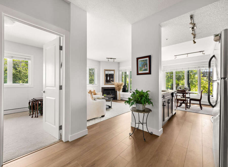 Step into this beautifully appointed living space, featuring a cozy fireplace and ample natural light.