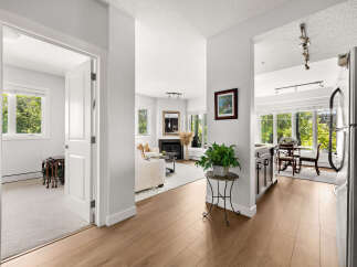 Step into this beautifully appointed living space, featuring a cozy fireplace and ample natural light.