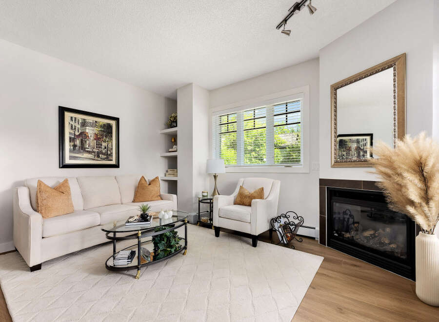 Experience comfort and style in this inviting living room, featuring a plush sofa and a cozy armchair perfect for relaxation.