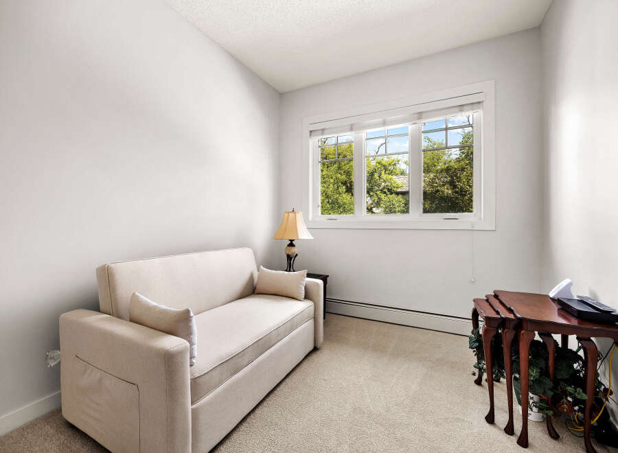 This cozy room features a comfortable sofa, perfect for relaxing or accommodating guests.