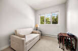 This cozy room features a comfortable sofa, perfect for relaxing or accommodating guests.