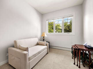 This cozy room features a comfortable sofa, perfect for relaxing or accommodating guests.