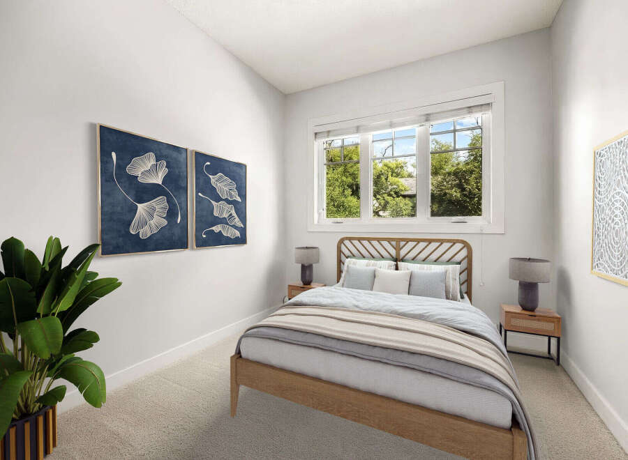 This inviting bedroom features a stylish wooden bed with a unique headboard, complemented by soft, neutral bedding.