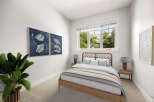 This inviting bedroom features a stylish wooden bed with a unique headboard, complemented by soft, neutral bedding.