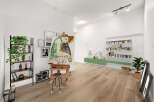 This spacious living area is perfect for artists and book lovers, featuring a large easel with a captivating painting and ample shelving for your literary collection.