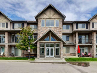 Discover modern living in this stunning multi-story apartment building, featuring a striking stone facade and elegant architectural details.