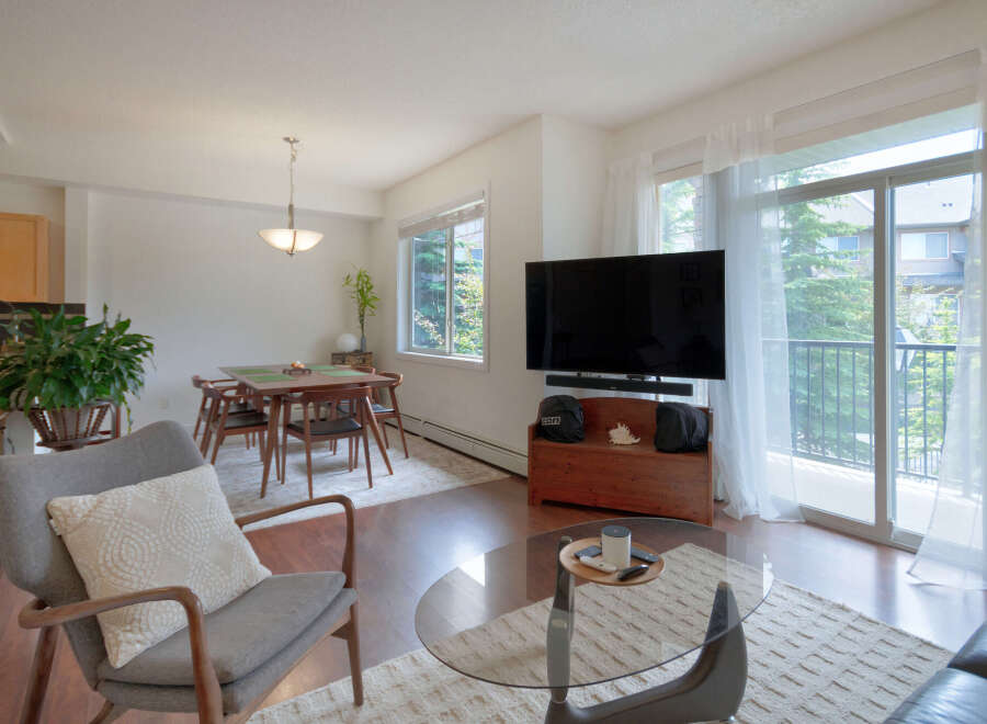 Experience modern living in this bright and airy condo, featuring a spacious open-concept living and dining area perfect for entertaining.
