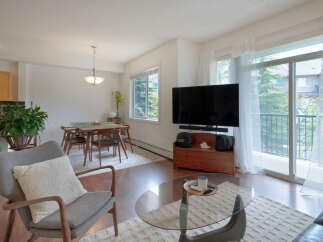 Experience modern living in this bright and airy condo, featuring a spacious open-concept living and dining area perfect for entertaining.