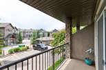 Enjoy your morning coffee on this private balcony overlooking a well-maintained complex with ample parking and green spaces.