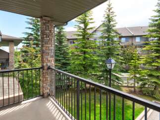 Enjoy your morning coffee on this private balcony overlooking lush greenery and mature trees.