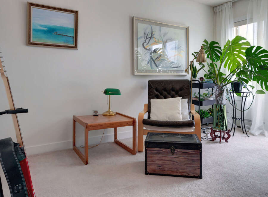 This living room features a comfortable armchair with a plush cushion, perfect for relaxing.
