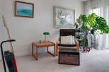 This living room features a comfortable armchair with a plush cushion, perfect for relaxing.