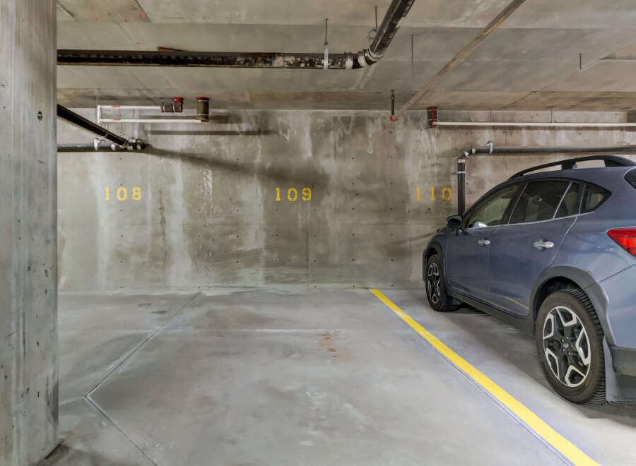 Discover convenient underground parking at this property, featuring assigned spots marked with clear numbering.