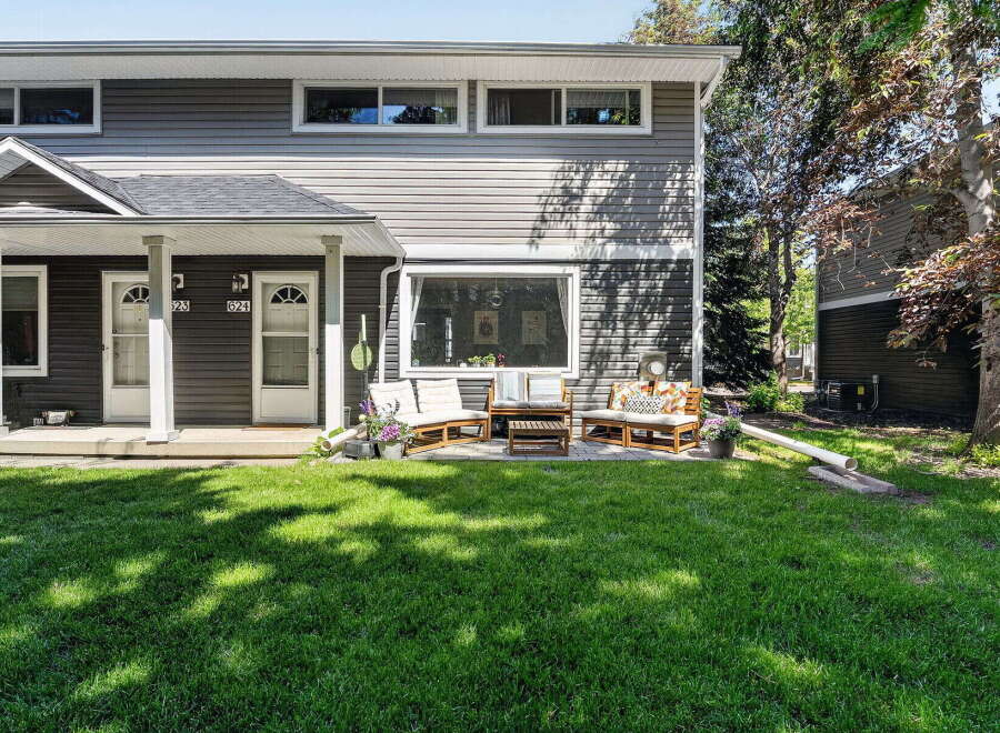 Charming townhome living awaits with a welcoming front porch and a private patio perfect for outdoor relaxation.