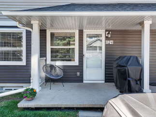 Welcome to this charming home featuring a covered front porch, perfect for enjoying your morning coffee.