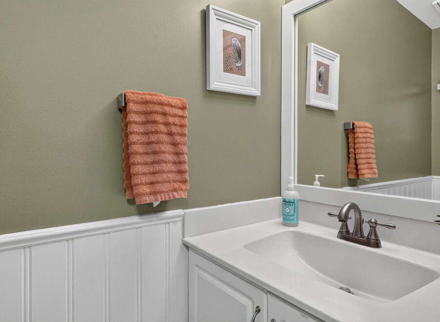 This bathroom features a stylish vanity with a white countertop and a modern brushed nickel faucet.