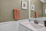 This bathroom features a stylish vanity with a white countertop and a modern brushed nickel faucet.