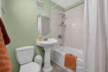 This bathroom features a clean and functional design with a white pedestal sink and a matching toilet.