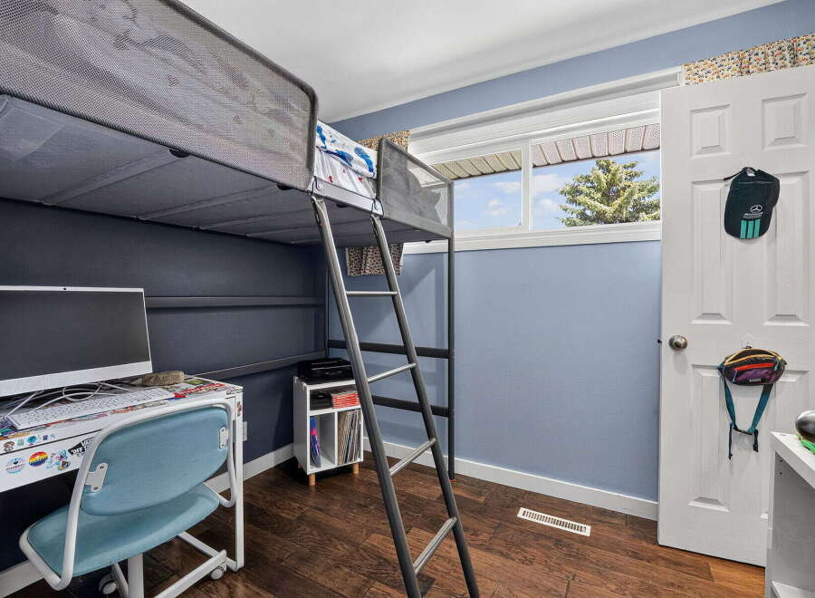This bedroom features a space-saving loft bed, perfect for maximizing floor space.