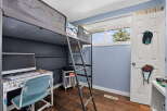 This bedroom features a space-saving loft bed, perfect for maximizing floor space.