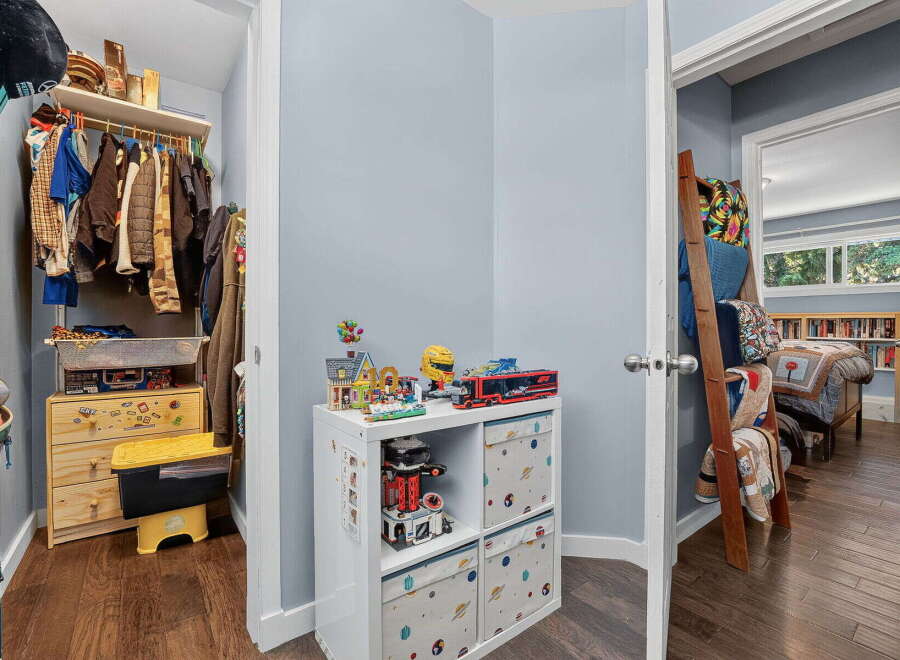 Discover organized living with a spacious walk-in closet featuring ample hanging space and storage drawers, perfect for keeping your wardrobe tidy.