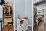 Discover organized living with a spacious walk-in closet featuring ample hanging space and storage drawers, perfect for keeping your wardrobe tidy.