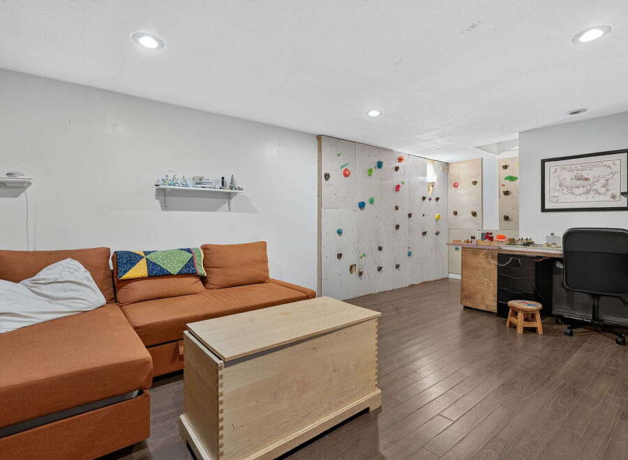 Discover this unique recreational space featuring a built-in climbing wall, perfect for active individuals and families.