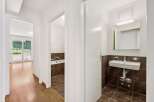 Step into this charming apartment featuring a well-appointed bathroom with a bathtub and a separate sink area.