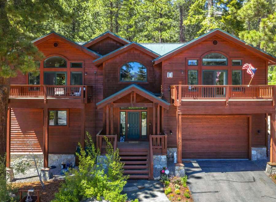 Nestled amidst towering pine trees, this stunning wooden mountain home offers a serene retreat.