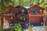 Nestled amidst towering pine trees, this stunning wooden mountain home offers a serene retreat.