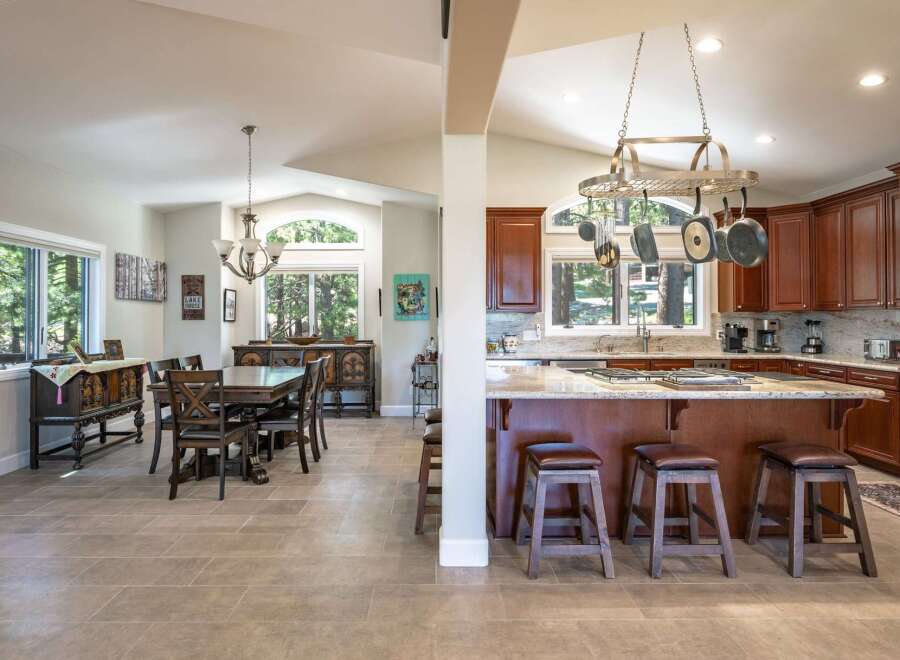 Experience the perfect blend of comfort and style in this spacious open-concept living area, featuring a formal dining room adjacent to a gourmet kitchen.