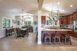 Experience the perfect blend of comfort and style in this spacious open-concept living area, featuring a formal dining room adjacent to a gourmet kitchen.