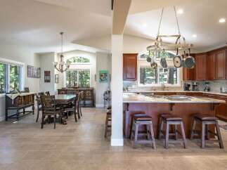 Experience the perfect blend of comfort and style in this spacious open-concept living area, featuring a formal dining room adjacent to a gourmet kitchen.