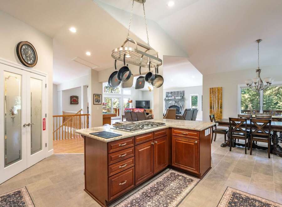 This spacious open-concept kitchen features a large island with a gas stovetop, perfect for culinary enthusiasts.