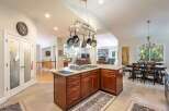 This spacious open-concept kitchen features a large island with a gas stovetop, perfect for culinary enthusiasts.