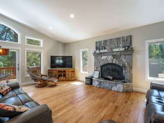 Experience cozy living in this spacious great room, featuring a stunning floor-to-ceiling stone fireplace as the centerpiece.