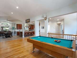 Experience open-concept living with this spacious home featuring a large dining area and a modern kitchen with ample counter space and bar seating.