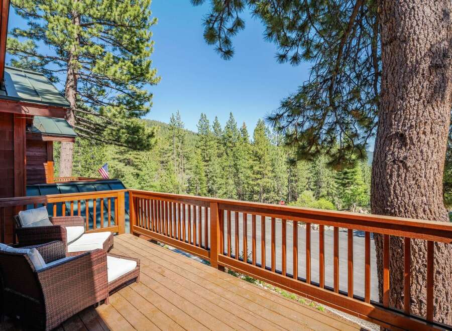 Enjoy the serene mountain views from this charming wooden deck, perfect for relaxing or entertaining.