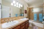 This spacious bathroom features a double vanity with ample counter space and two sinks, perfect for busy mornings.