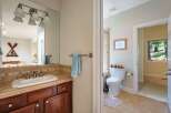 This charming bathroom features a spacious vanity with a tiled backsplash and a large mirror, perfect for your morning routine.