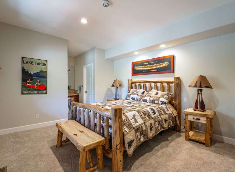 Experience rustic charm in this inviting bedroom, featuring a cozy log bed adorned with wildlife-themed bedding.